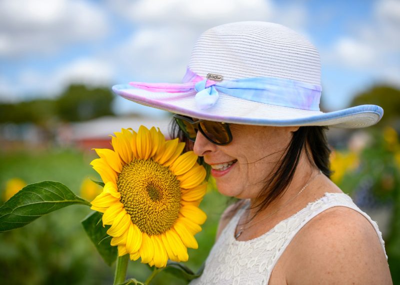 woman wearing hat with sunflower